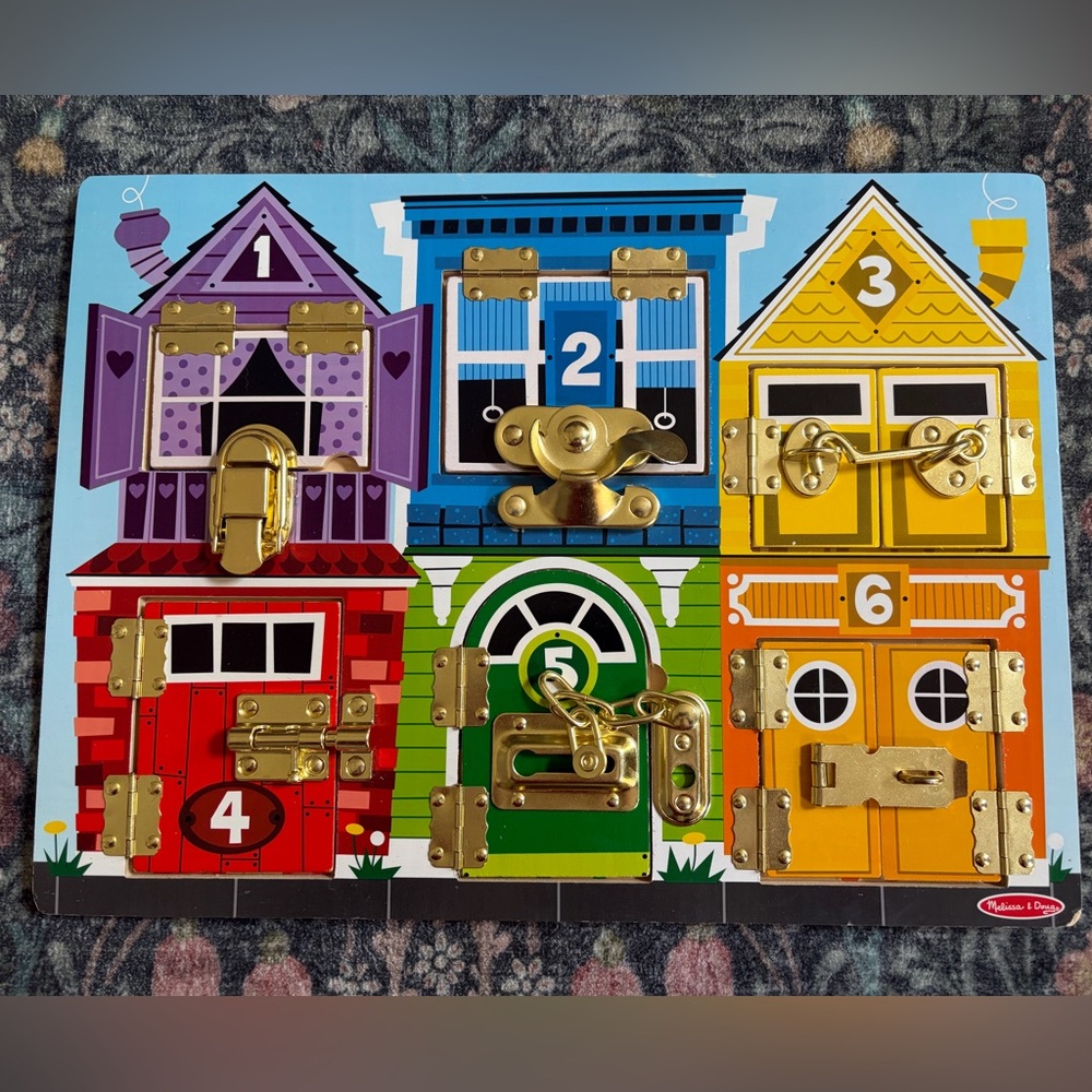 Melissa & Doug Colorful House Lockboard - Purple Blue Yellow Red Green Orange